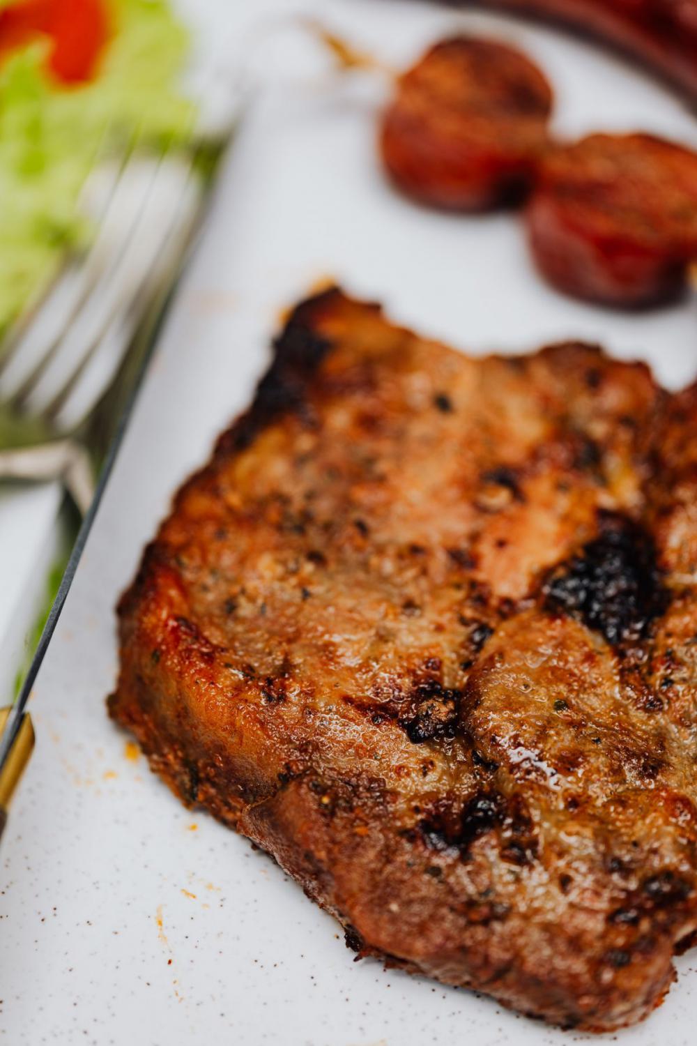The pork neck is roasted on the grill The pork neck is roasted on the grill