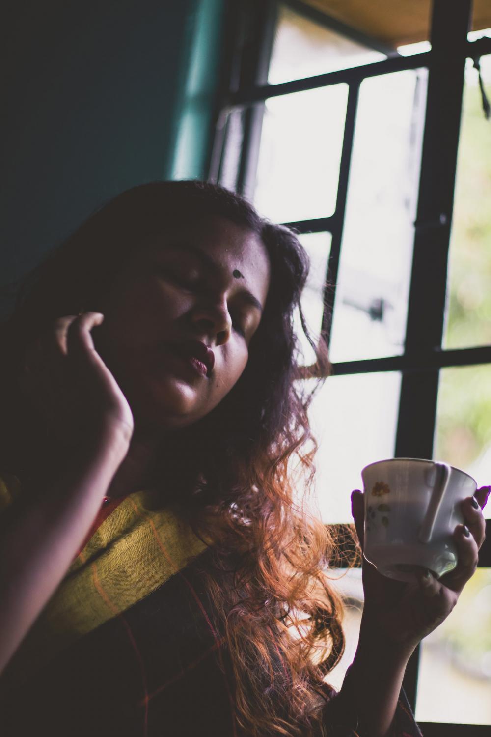 Woman At A Window Drinking Her Tea Photo Woman At A Window Drinking Her Tea Photo