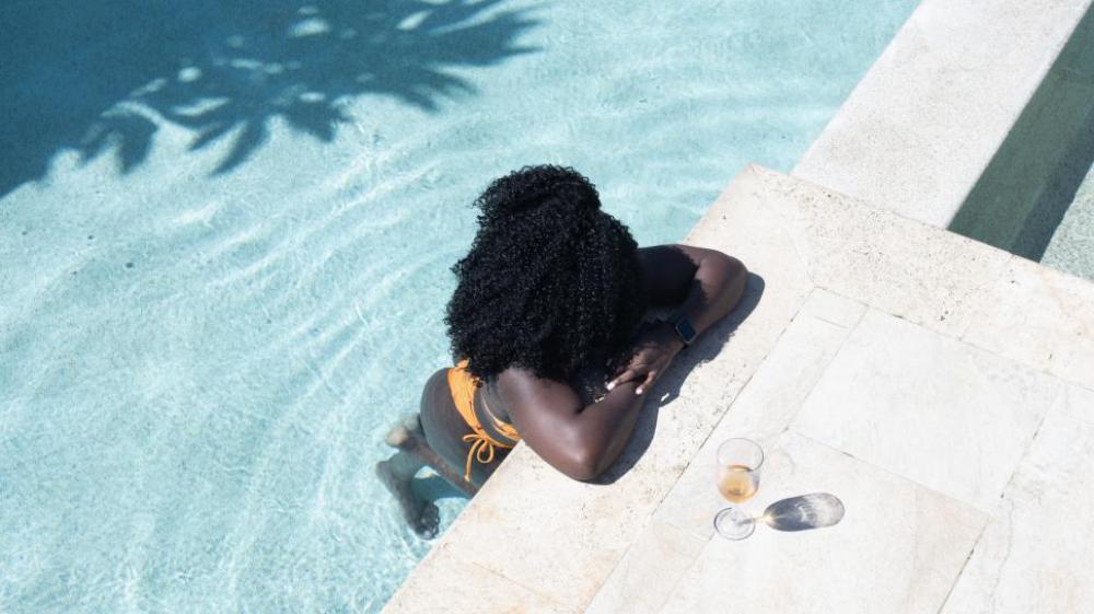 Young Woman relaxing in Swimming Pool Young Woman relaxing in Swimming Pool