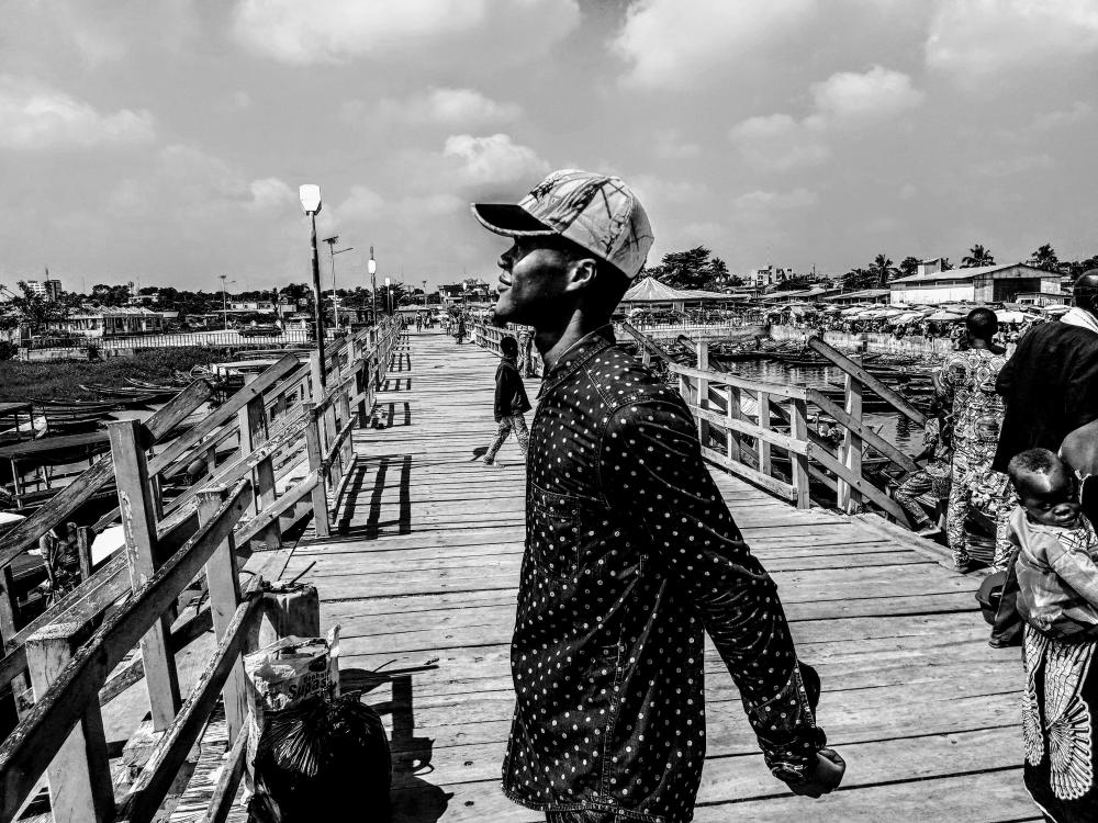 people, pedestrian, walk, promenade, man, cap, hat, look, smile, facial expression, watercraft, street, black and white, posture people, pedestrian, walk, promenade, man, cap, hat, look, smile, facial expression, watercraft, street, black and white, posture