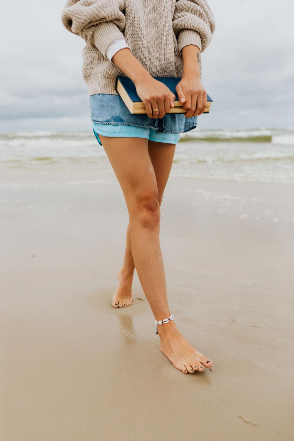 A young woman with a book on the seashore A young woman with a book on the seashore