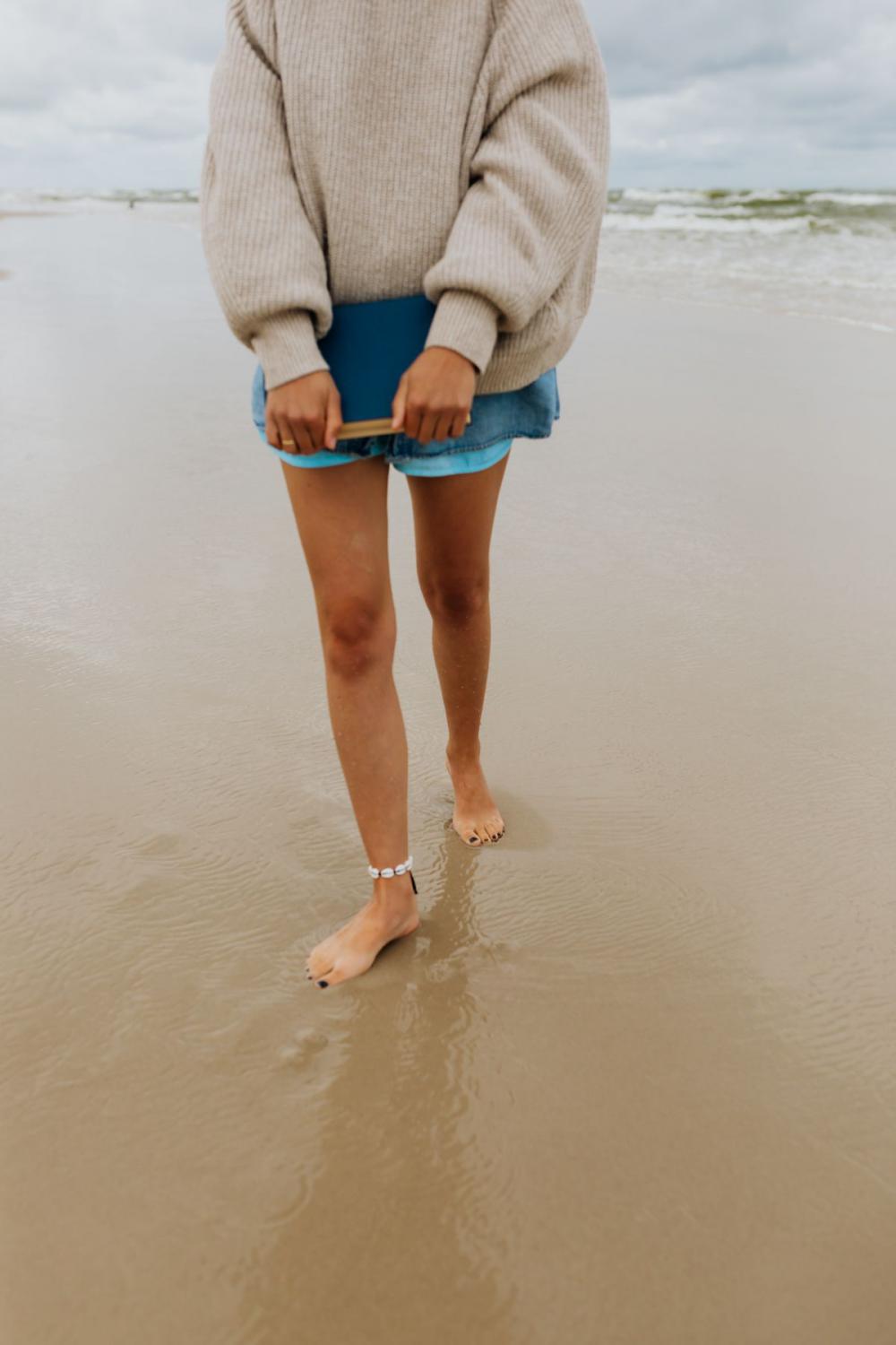 A young woman with a book on the seashore A young woman with a book on the seashore