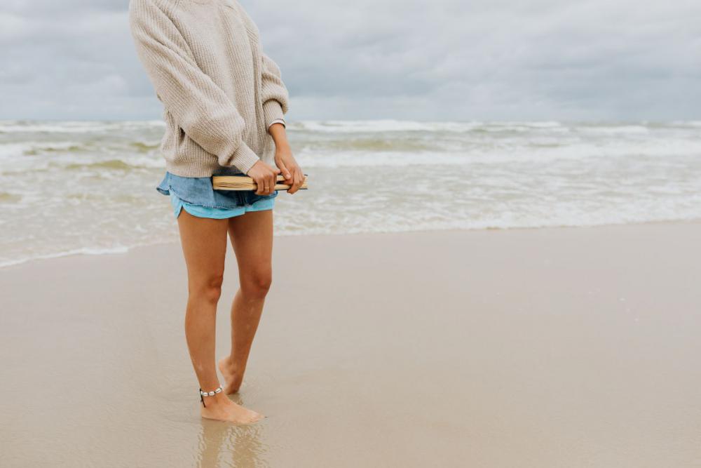 A young woman with a book on the seashore A young woman with a book on the seashore