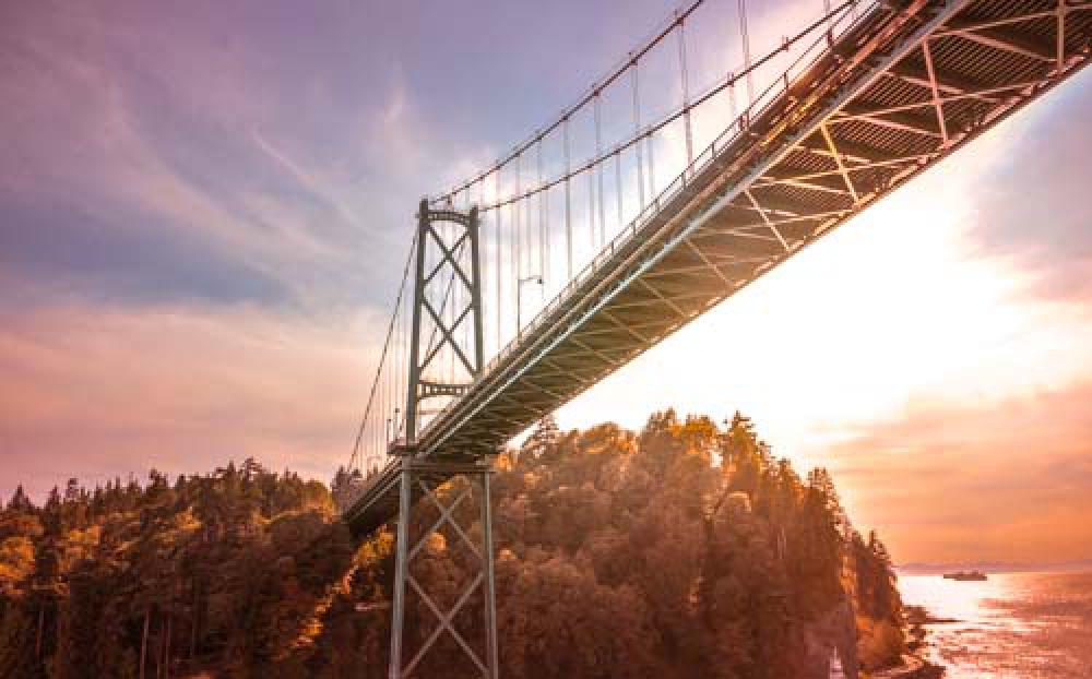 Dramatic Road Bridge At Sunset Over Water Leading To Autumn Forest Dramatic Road Bridge At Sunset Over Water Leading To Autumn Forest