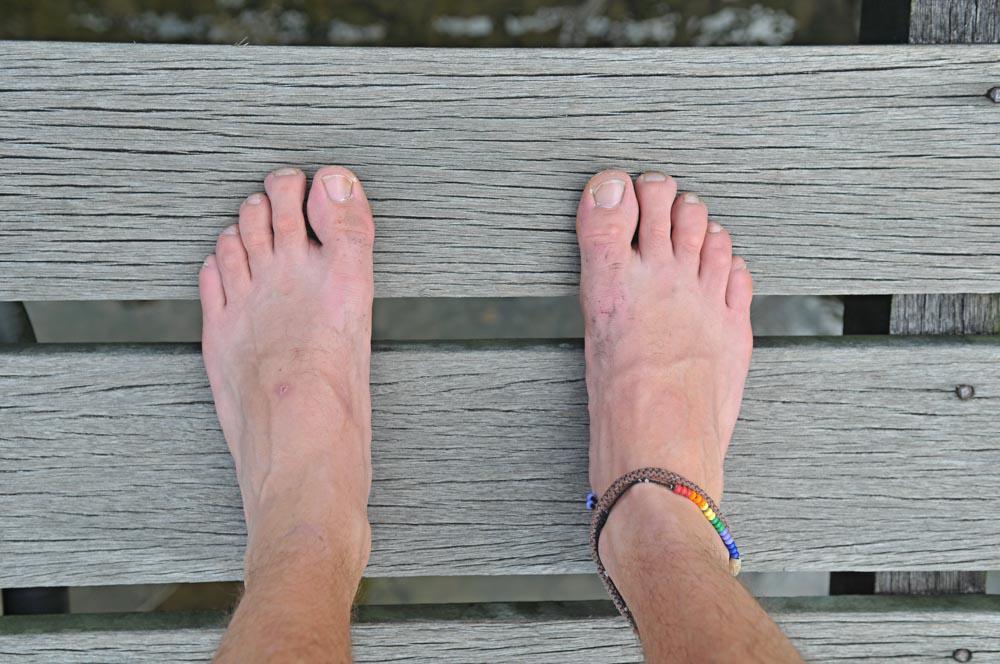 Well Travelled Mans Feet On Wood With Friendship anklet Well Travelled Mans Feet On Wood With Friendship anklet