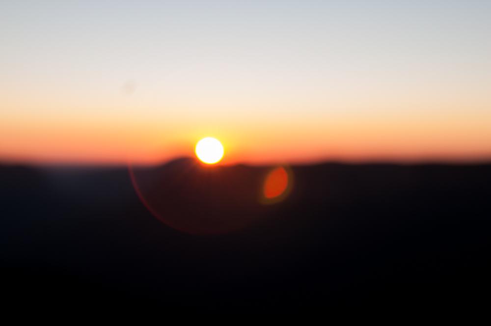 Out Of Focus Blur Of Sunrise Over Mountains Out Of Focus Blur Of Sunrise Over Mountains