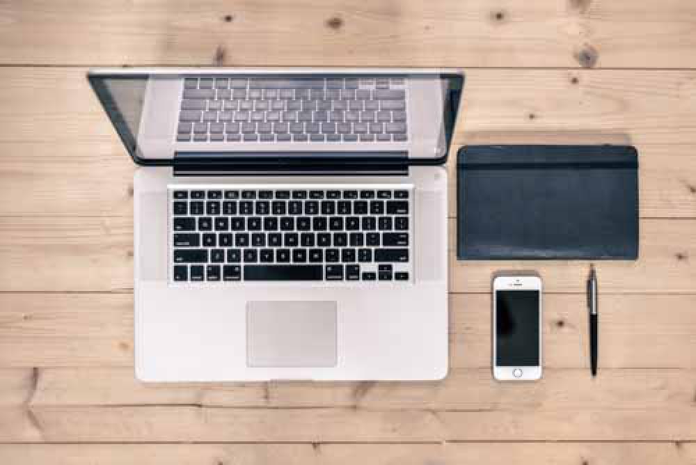 Opn Laptop With Work Book, iPhone And Pen On Wooden Desk Opn Laptop With Work Book, iPhone And Pen On Wooden Desk