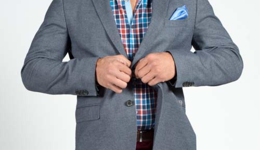Man Buttoning Shirt Of Smart Grey Jacket And Plaid Shirt Man Buttoning Shirt Of Smart Grey Jacket And Plaid Shirt