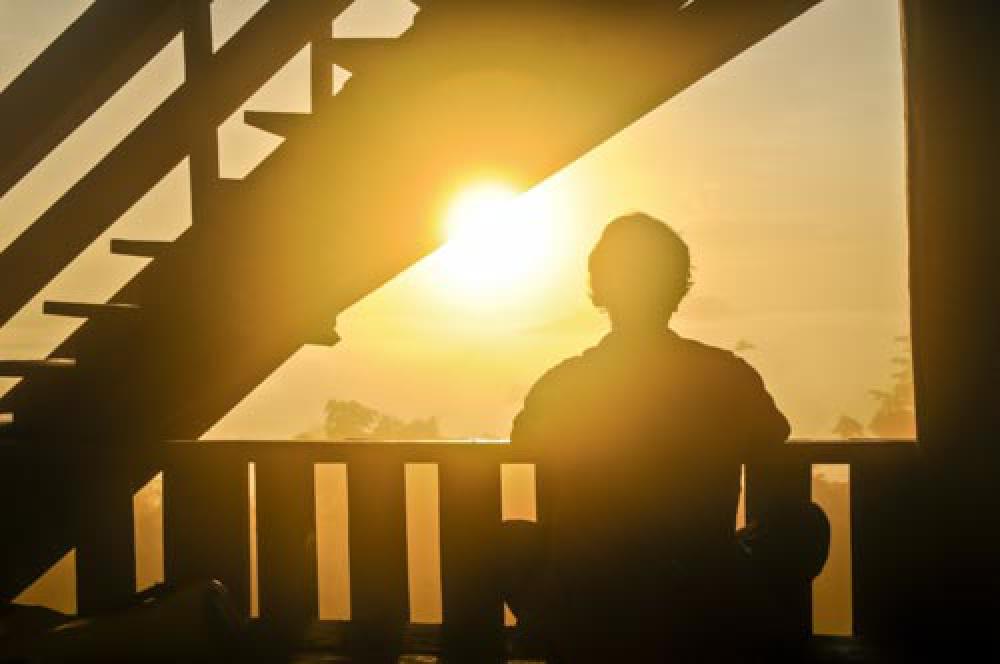 Man Watching Sunrise On Balcony Man Watching Sunrise On Balcony