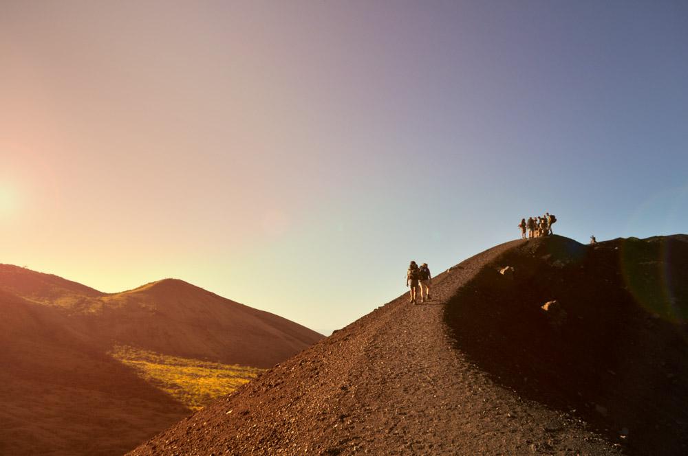 Group Of People Hiking Up A Mountain Ridge Group Of People Hiking Up A Mountain Ridge