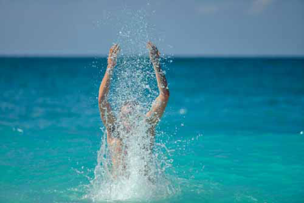 Happy Man Splashing Water In The Ocean Happy Man Splashing Water In The Ocean