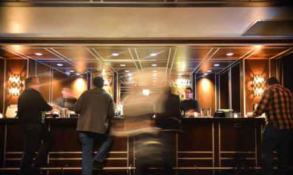 Men Standing At A Trendy Bar With Movement Men Standing At A Trendy Bar With Movement