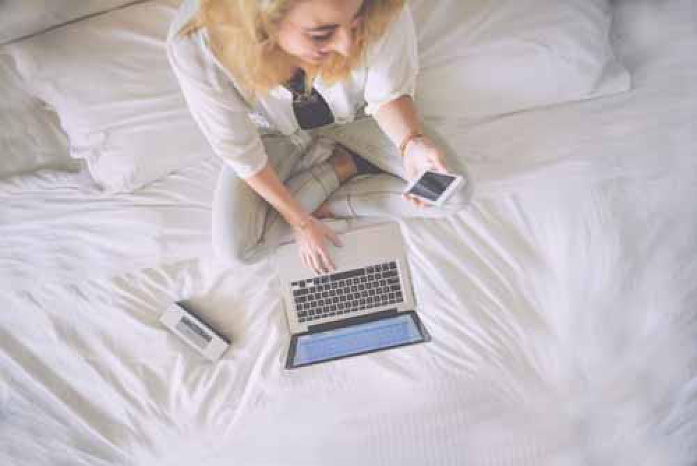 Girl Happy Woking On Laptop And Smartphone In Bed Girl Happy Woking On Laptop And Smartphone In Bed