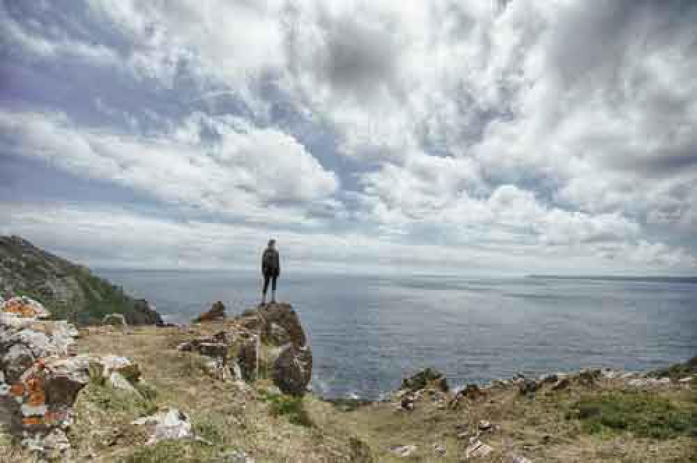 Hiking Girl Looking at Dramatic Sea Landscape Hiking Girl Looking at Dramatic Sea Landscape