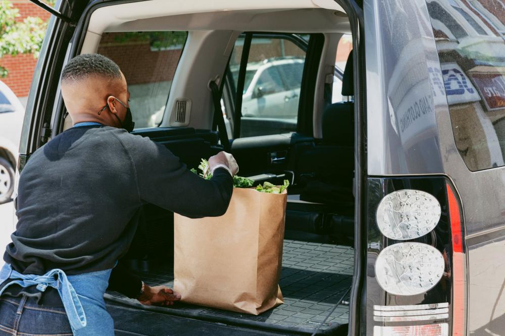 Store Staff Places Customer Order In Back Of Car Photo Store Staff Places Customer Order In Back Of Car Photo