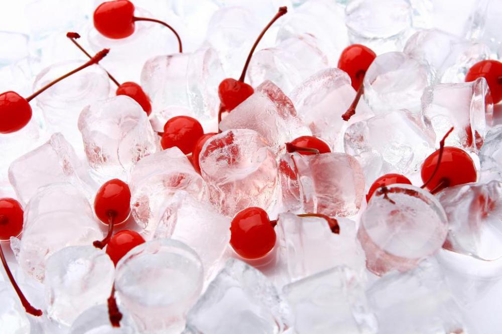 Ice with red dessert cherries Ice with red dessert cherries