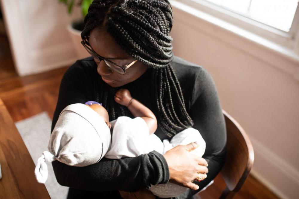 Young caring mother with sleeping baby at home Young caring mother with sleeping baby at home