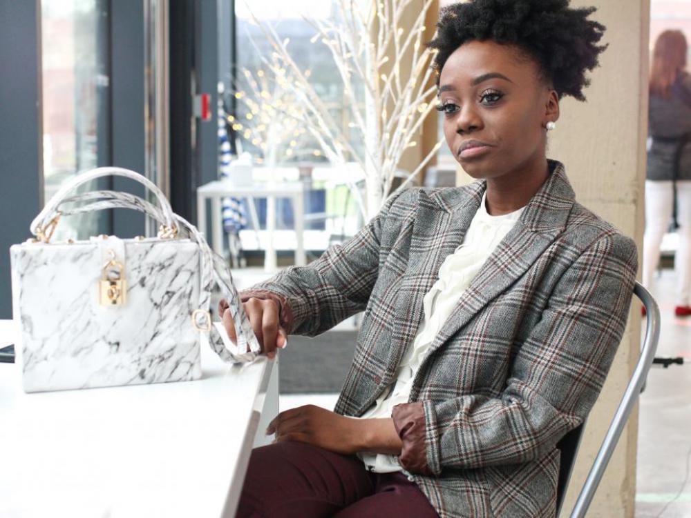 Young business woman in tweed blazer - looking thoughtful Young business woman in tweed blazer - looking thoughtful