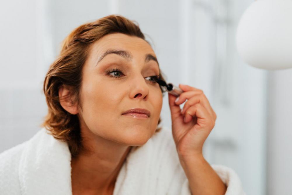 Skincare routine - Middle-Aged Woman in Bathroom Skincare routine - Middle-Aged Woman in Bathroom