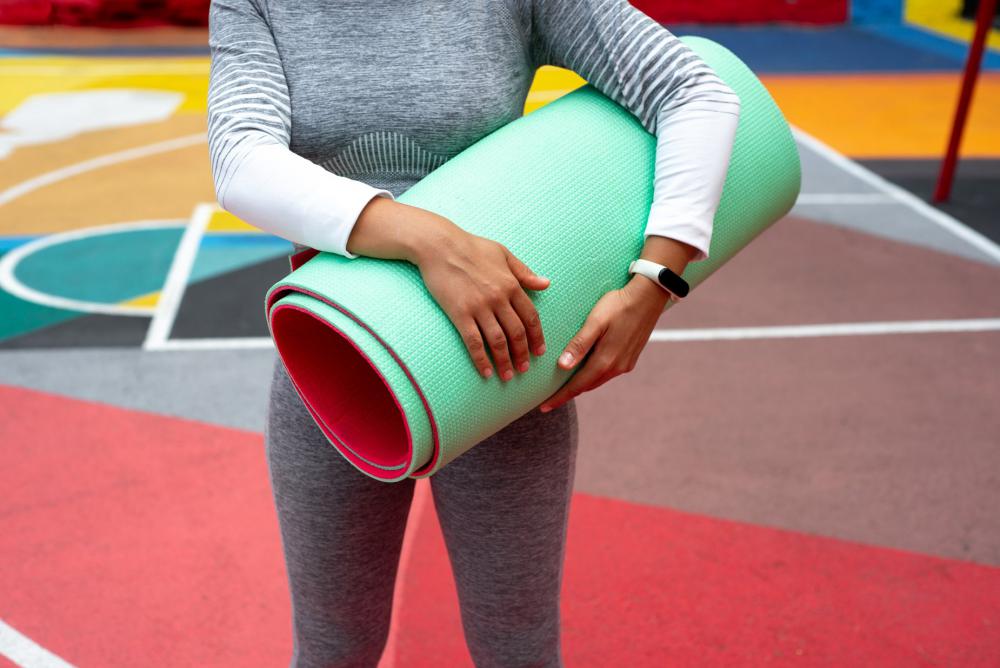 Walking With Rolled Up Yoga Matt Photo Walking With Rolled Up Yoga Matt Photo