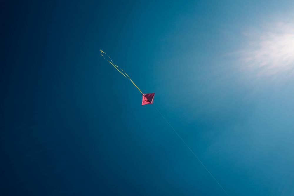 Minimalist Pink Kite Dots Through Blue Skies Photo Minimalist Pink Kite Dots Through Blue Skies Photo