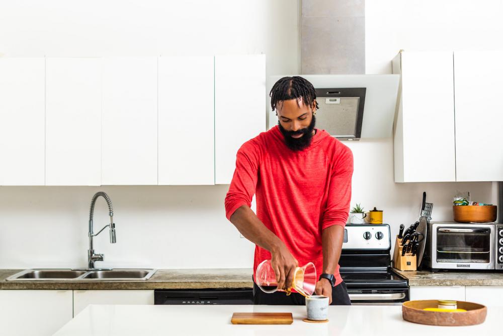 Man Makes Pour Over Coffee In Kitchen Photo Man Makes Pour Over Coffee In Kitchen Photo