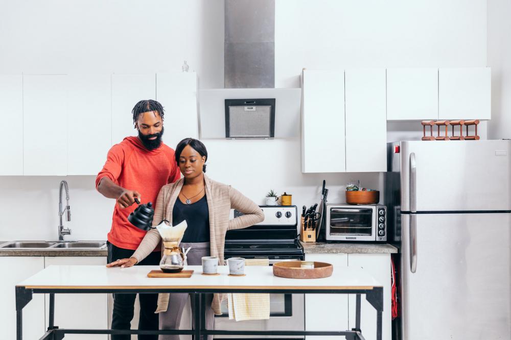 Pouring Coffee In A Bright White Kitchen Photo Pouring Coffee In A Bright White Kitchen Photo
