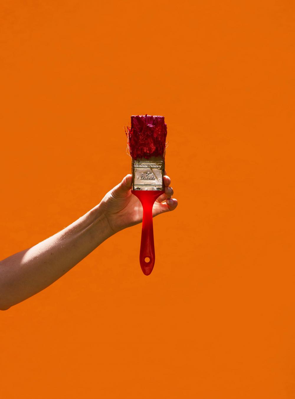 Illuminated Paint Brush On Orange Photo Illuminated Paint Brush On Orange Photo