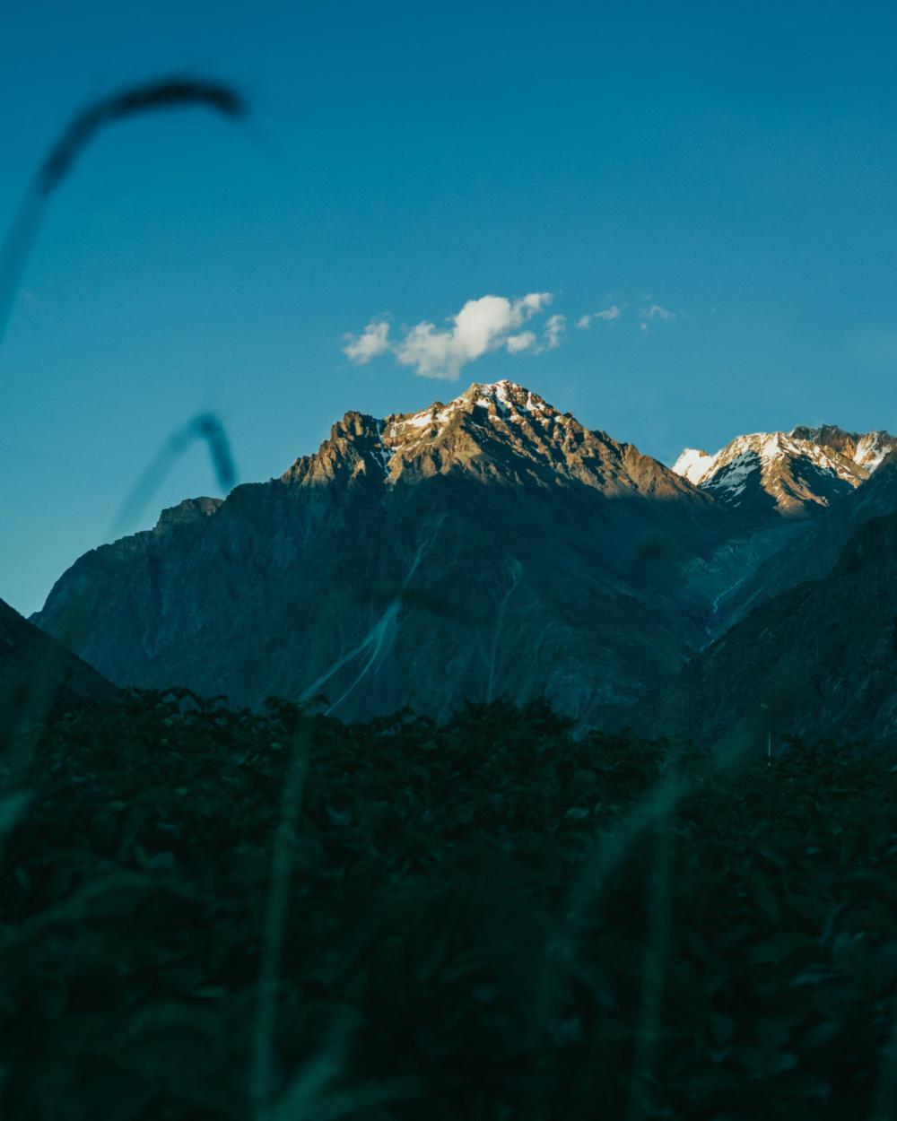Single Cloud Hovers Over Mountain Peak Photo Single Cloud Hovers Over Mountain Peak Photo