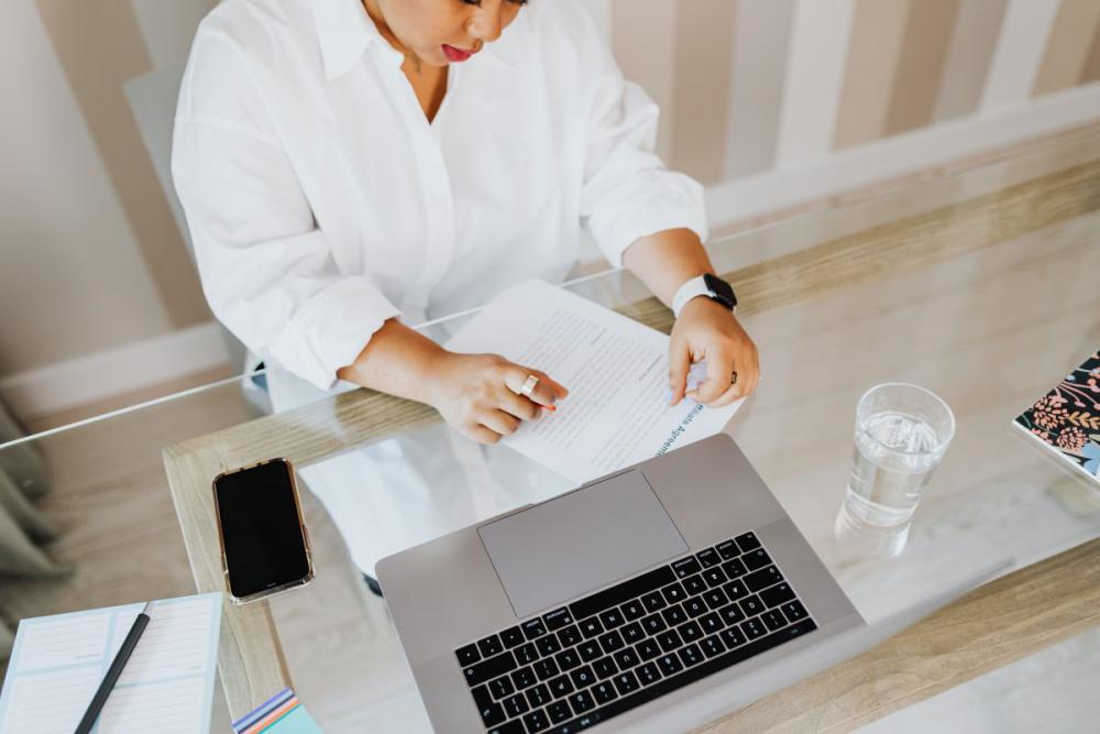 A young woman works on a laptop from home A young woman works on a laptop from home