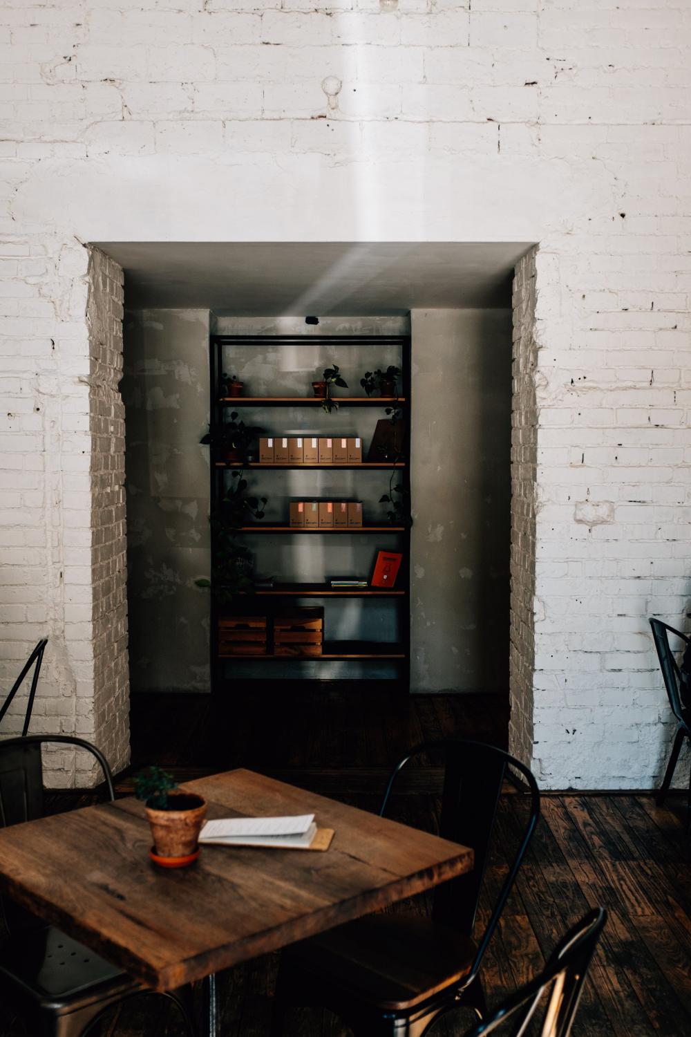 Wooden Table And Stocked Shelves Photo Wooden Table And Stocked Shelves Photo