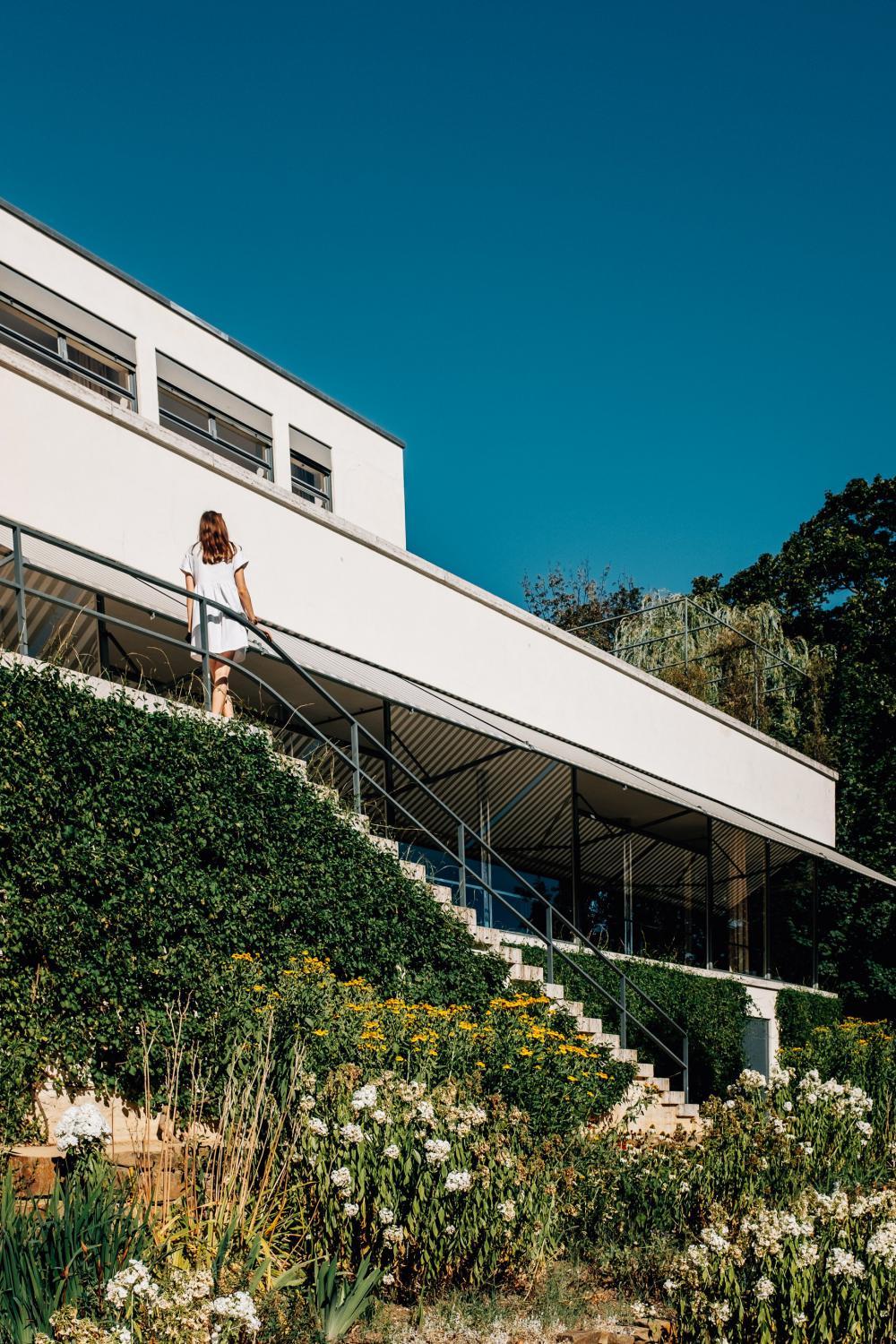 Person In White Dress Stands Outside On Steps Photo Person In White Dress Stands Outside On Steps Photo
