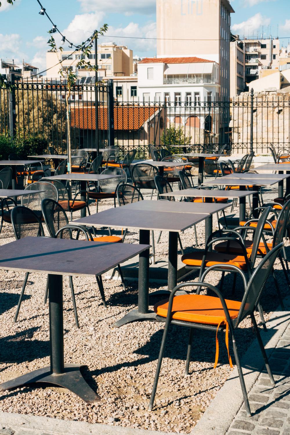 Orange Cushions On Metal Chairs In Empty Patio Photo Orange Cushions On Metal Chairs In Empty Patio Photo