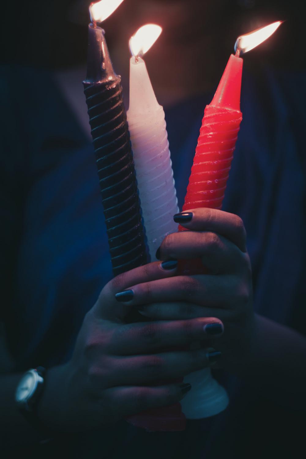 Hands Holding Tall Lit Candles Photo Hands Holding Tall Lit Candles Photo
