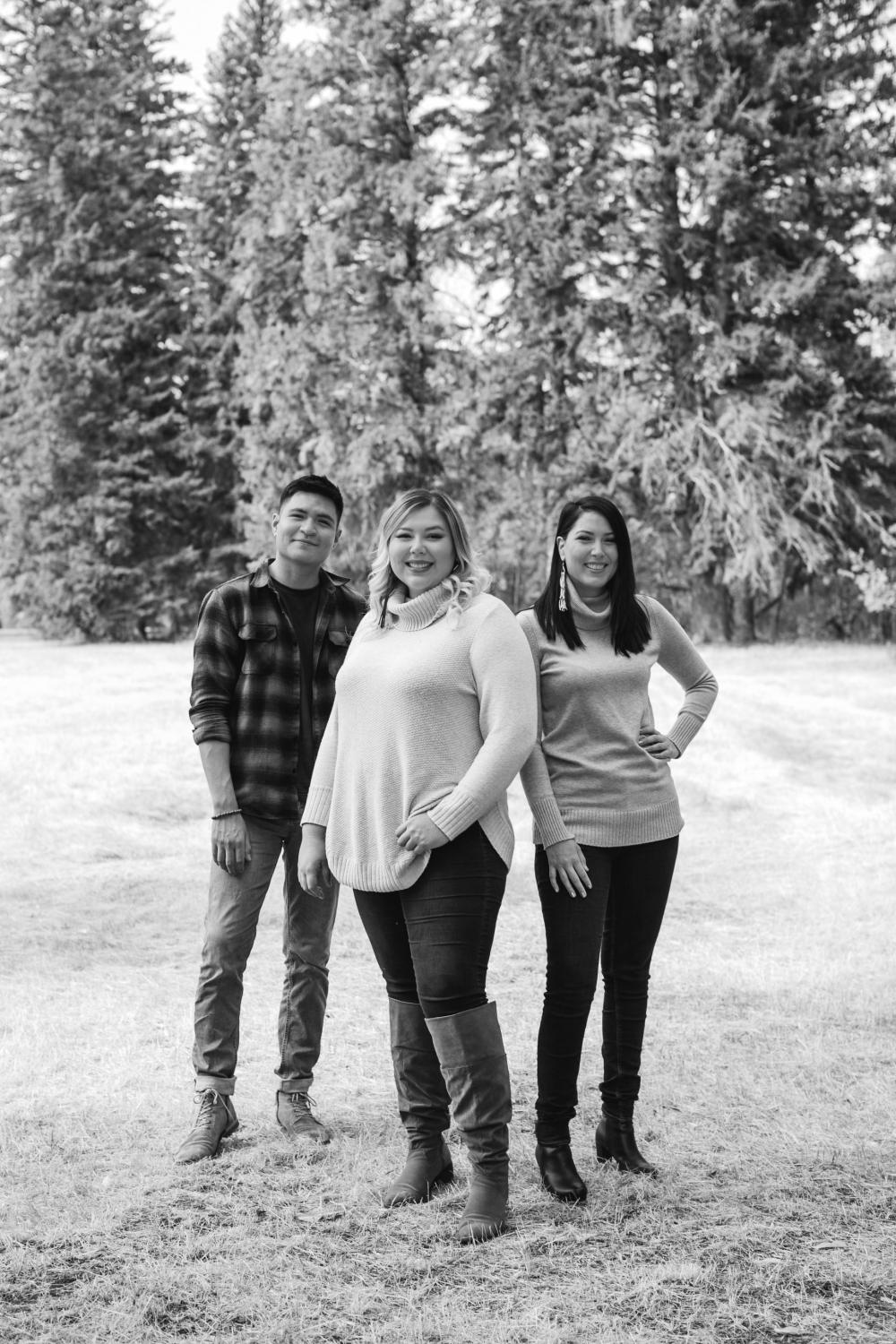 Three People Standing Outdoors And Smiling In Black And White Photo Three People Standing Outdoors And Smiling In Black And White Photo