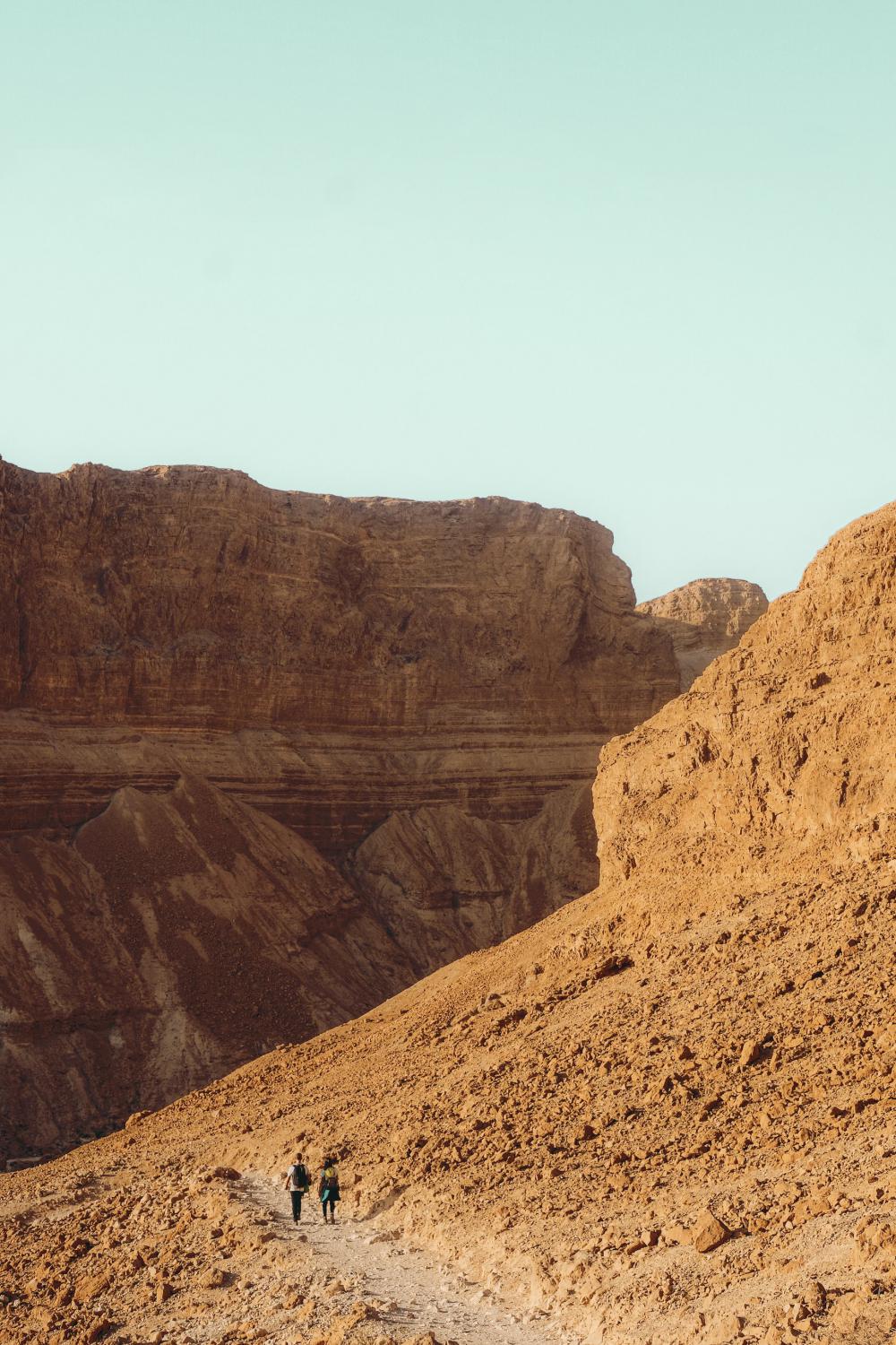Hikers On A Red Sandy Desert Hill Photo Hikers On A Red Sandy Desert Hill Photo