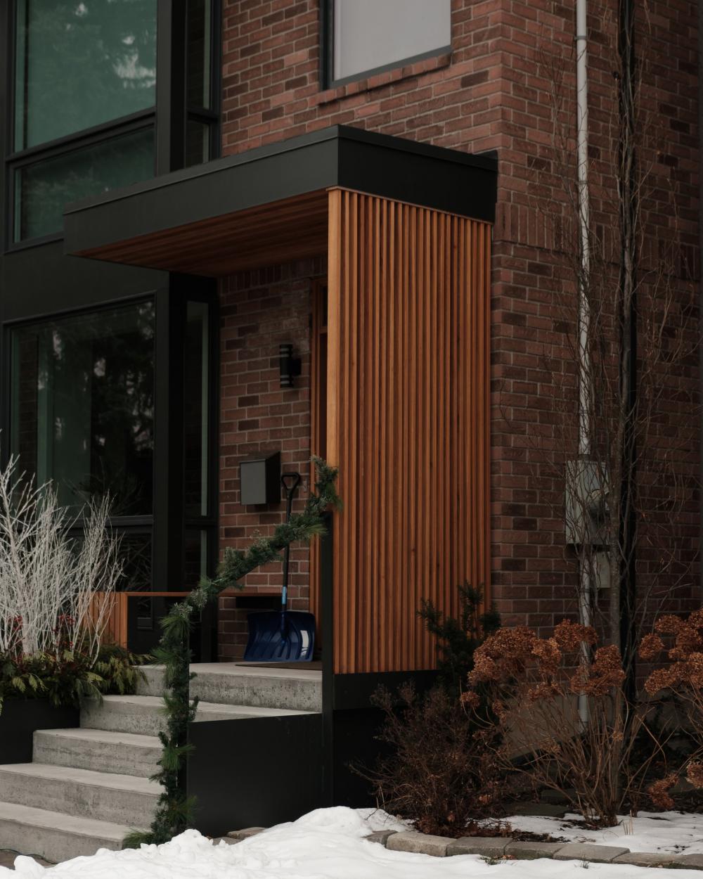 Red Brick Home With Snow Shovel By The Entrance Photo Red Brick Home With Snow Shovel By The Entrance Photo