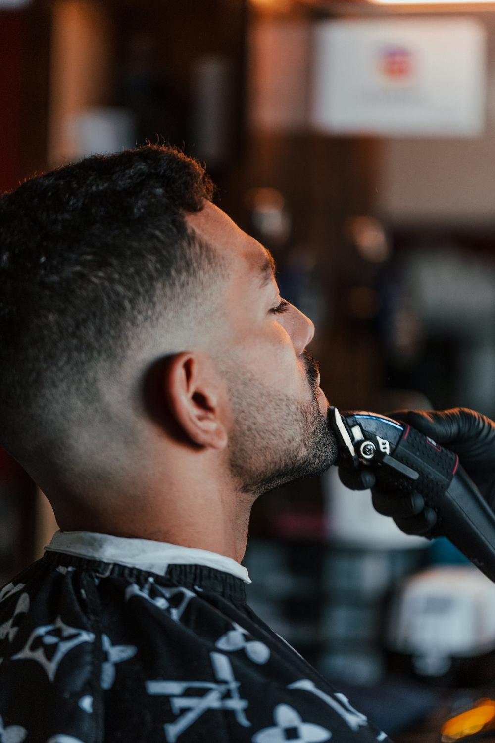 Man Getting His Beard Trimmed By Barber Photo Man Getting His Beard Trimmed By Barber Photo