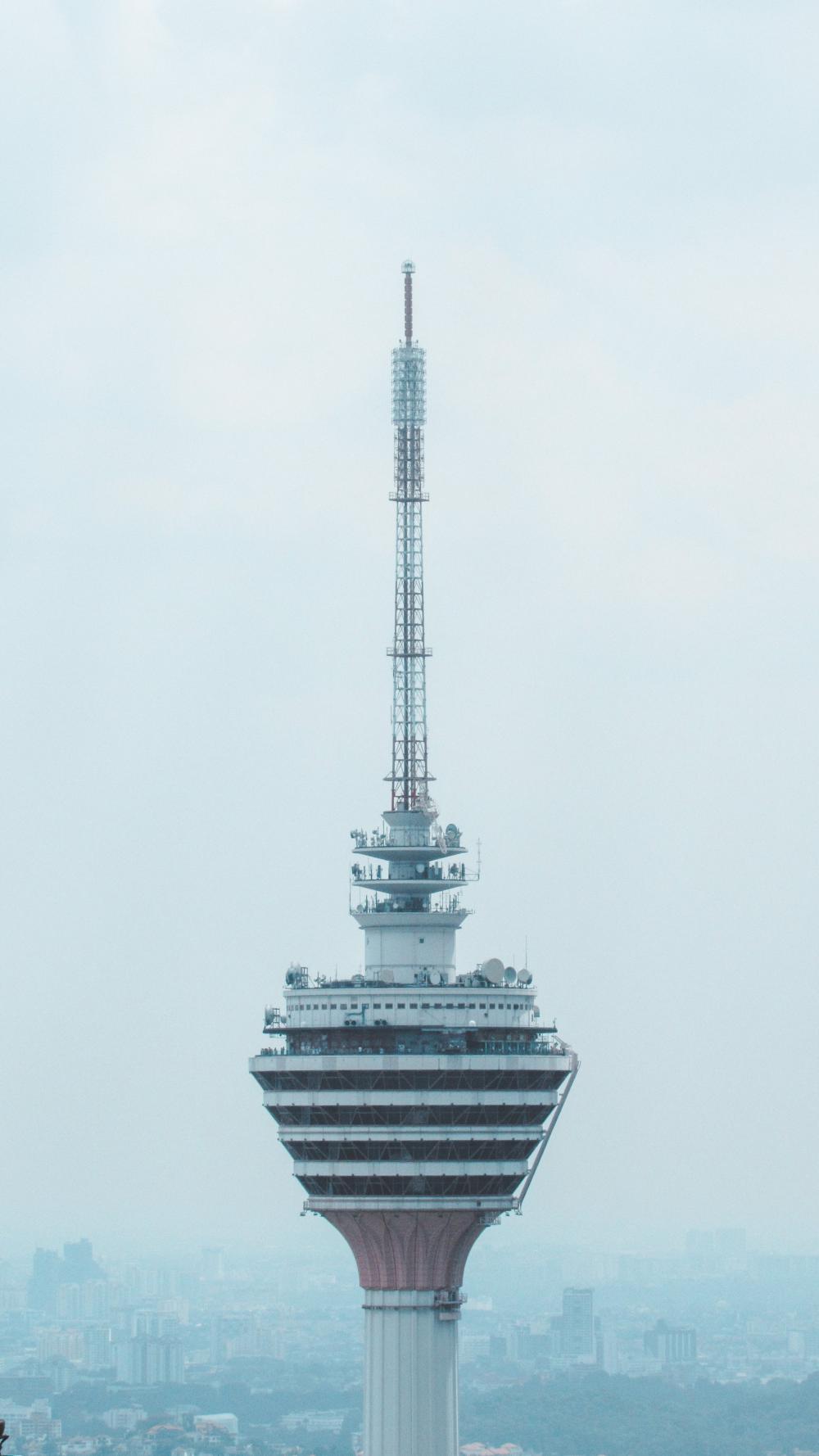 The Top Of A Skyscraper That Sits Above A City Photo The Top Of A Skyscraper That Sits Above A City Photo