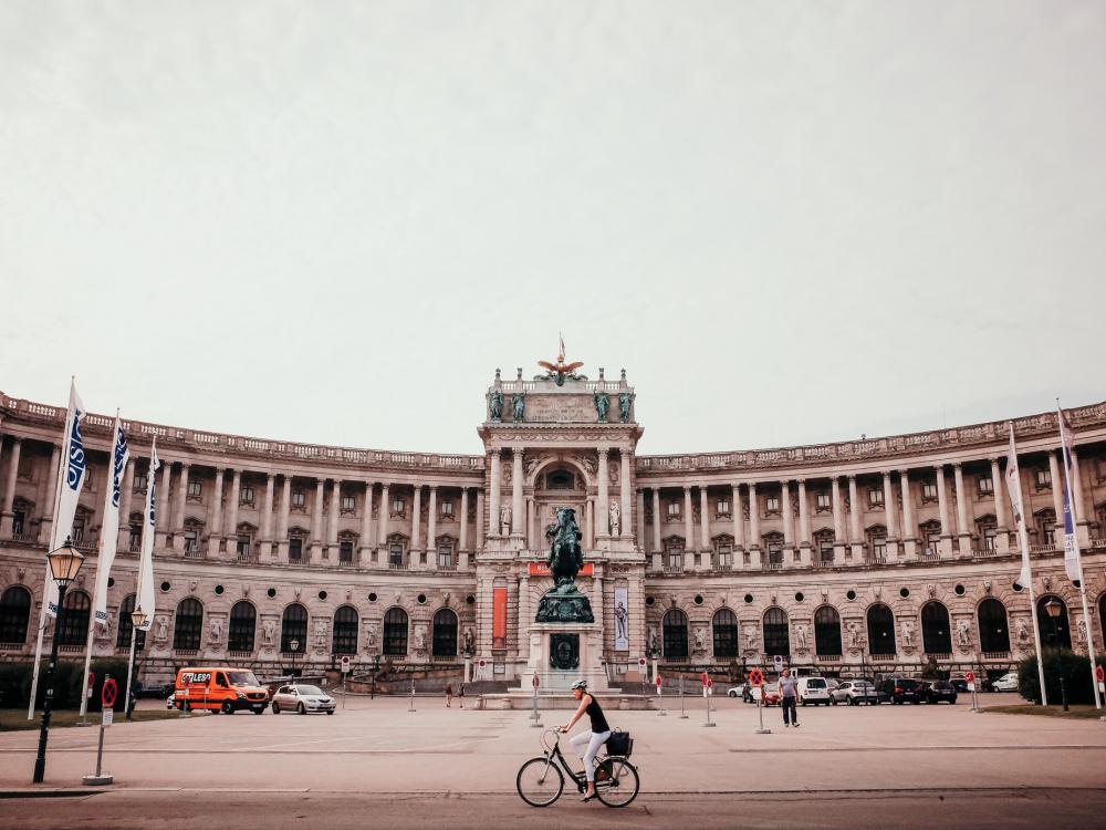 Person Bikes Past Wide Sculptural Courtyard Photo Person Bikes Past Wide Sculptural Courtyard Photo