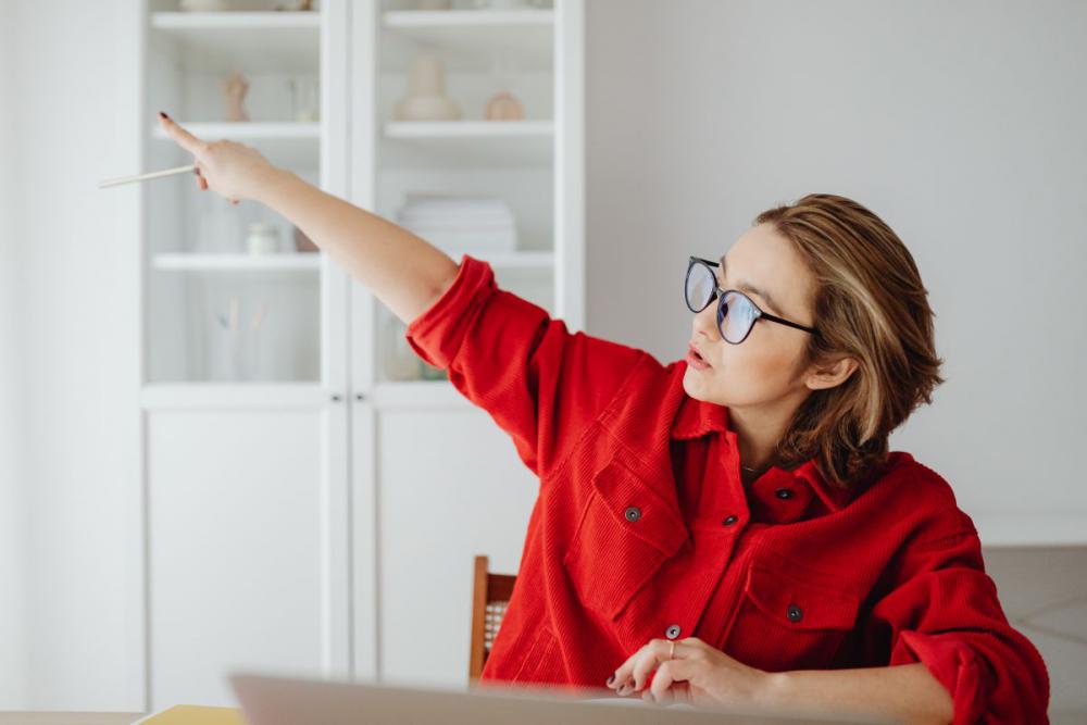 A woman works at a desk in her home A woman works at a desk in her home