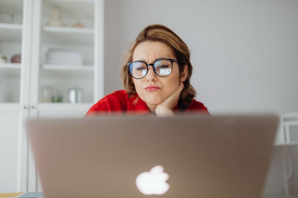 A woman works at a desk in her home A woman works at a desk in her home