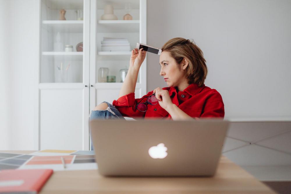 A woman works at a desk in her home A woman works at a desk in her home
