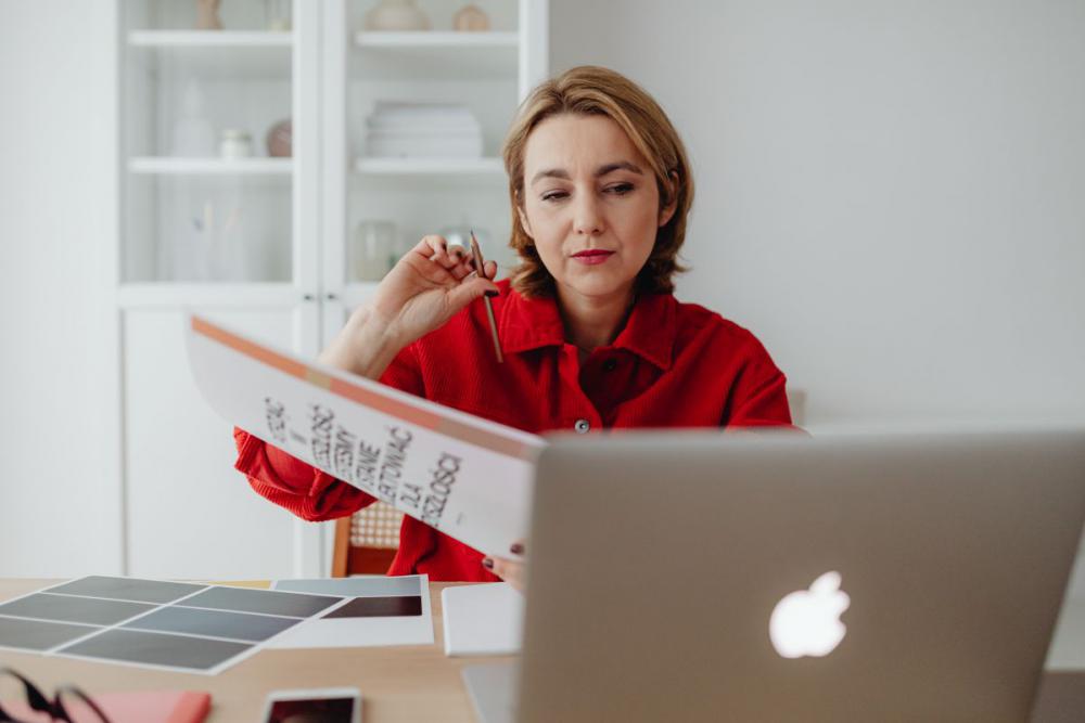 A woman works at a desk in her home A woman works at a desk in her home