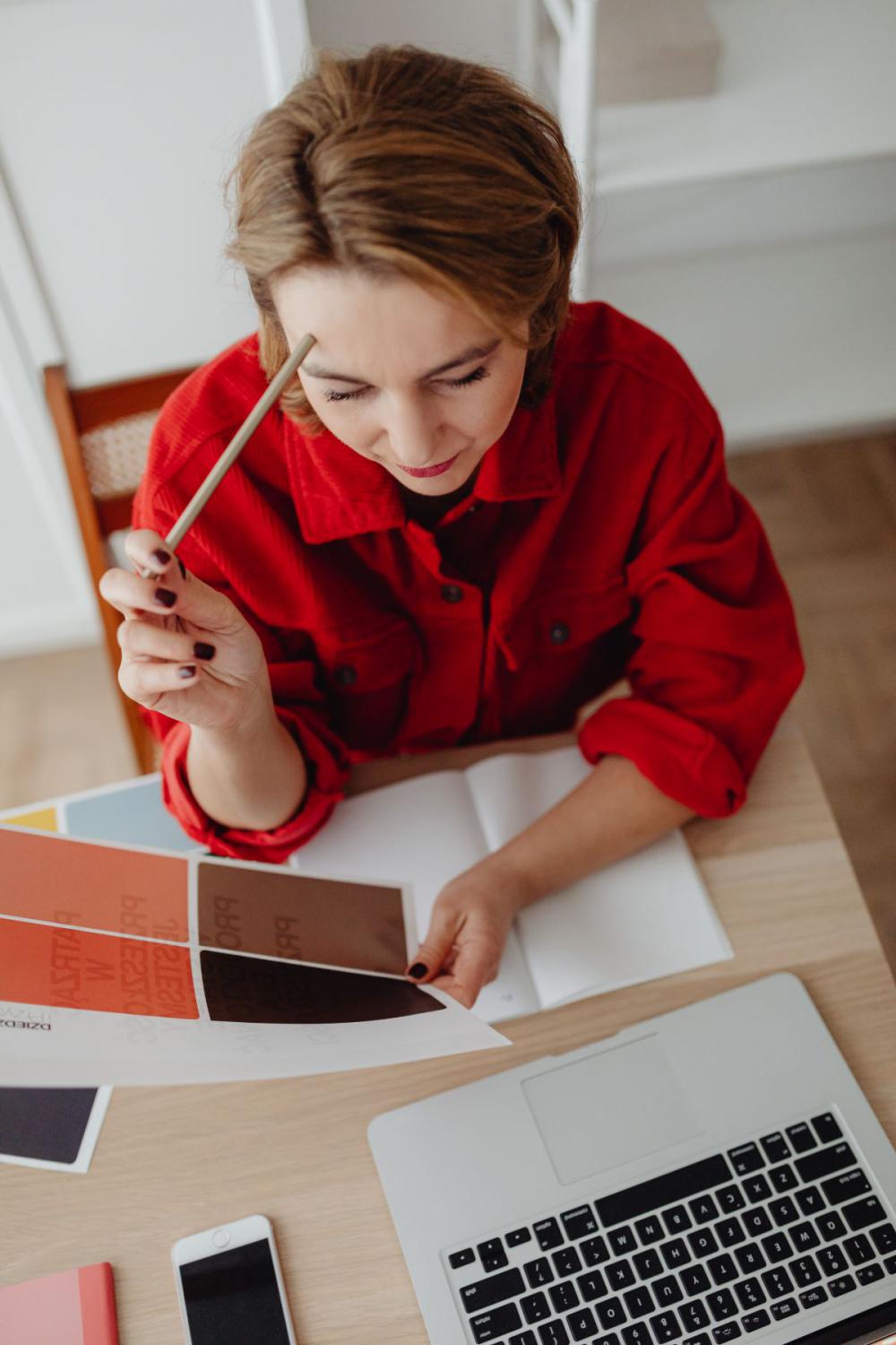 A woman works at a desk in her home A woman works at a desk in her home