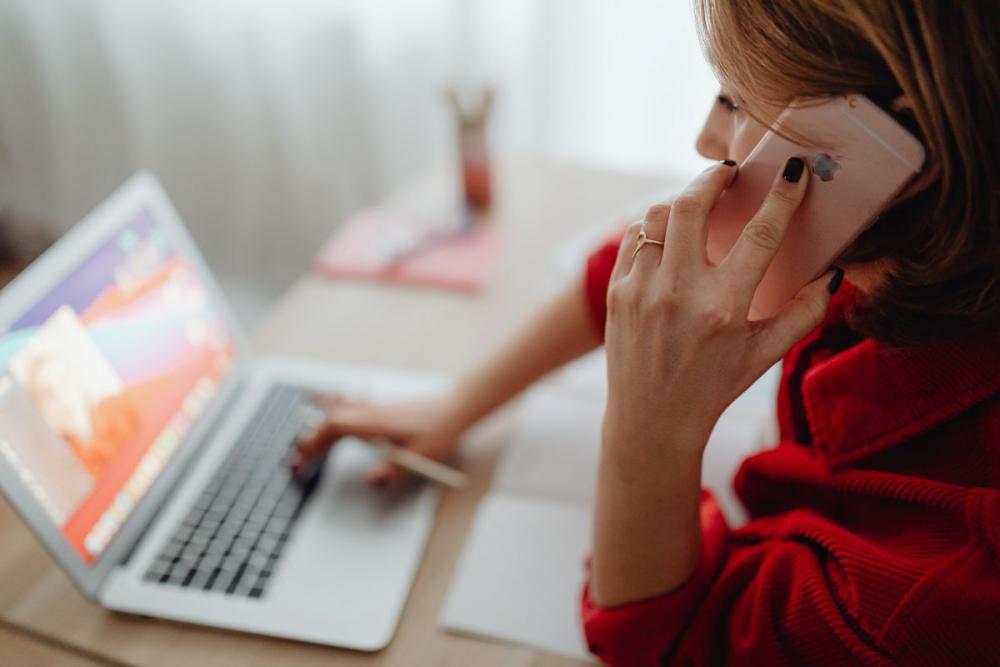 A woman works at a desk in her home A woman works at a desk in her home
