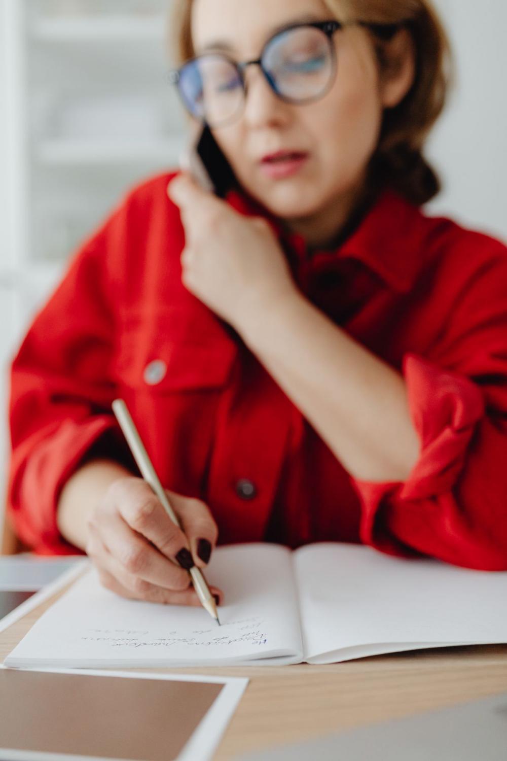 A woman works at a desk in her home A woman works at a desk in her home