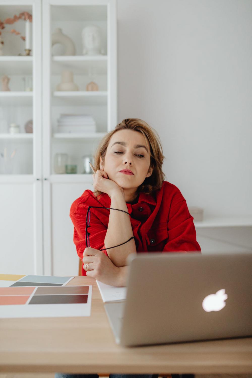 A woman works at a desk in her home A woman works at a desk in her home