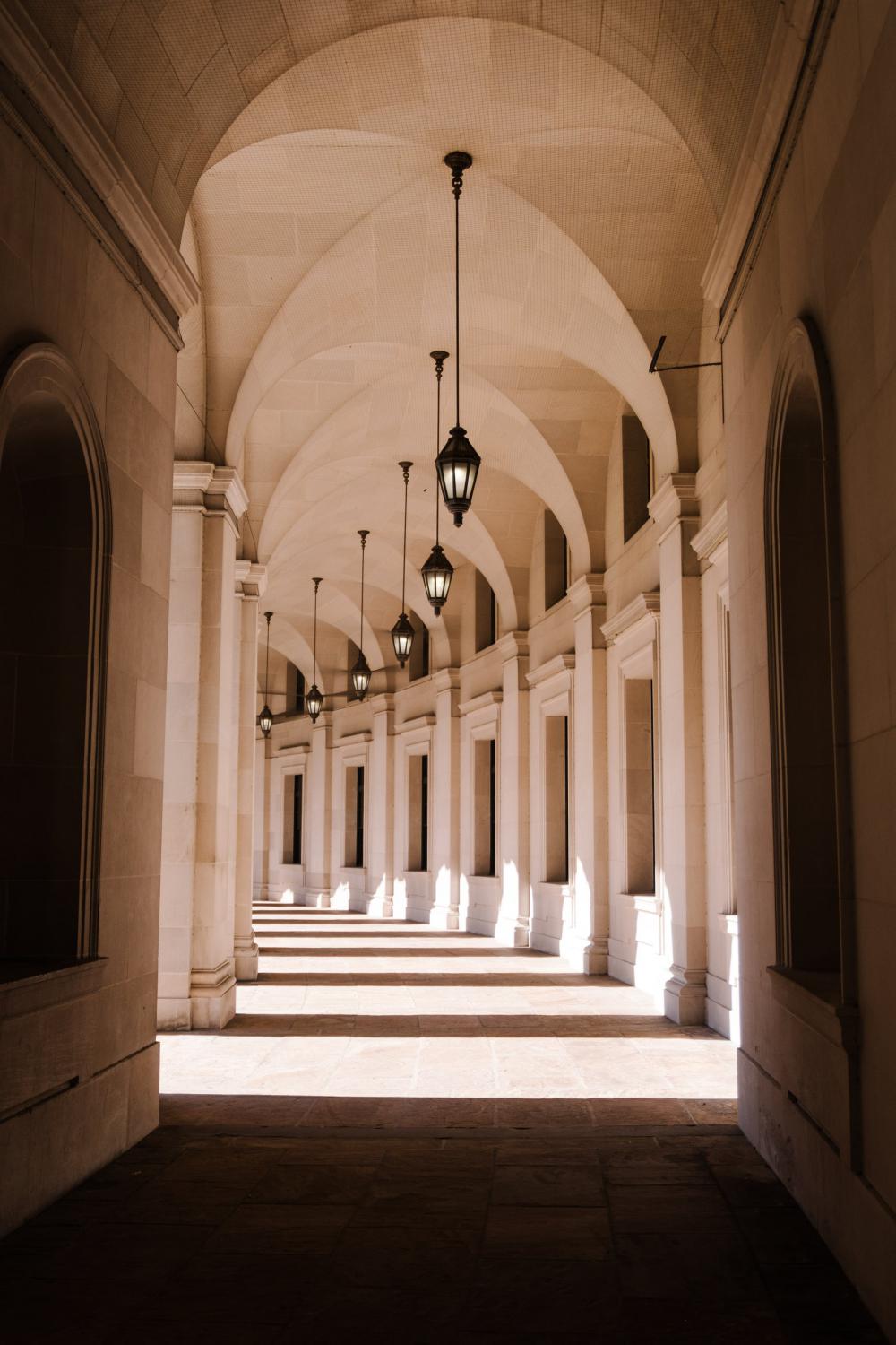 White Arched Hallway With Natural Light Photo White Arched Hallway With Natural Light Photo