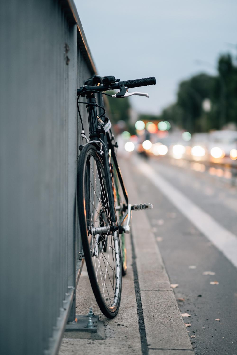 Bike Parked Up By Metal Fence Photo Bike Parked Up By Metal Fence Photo